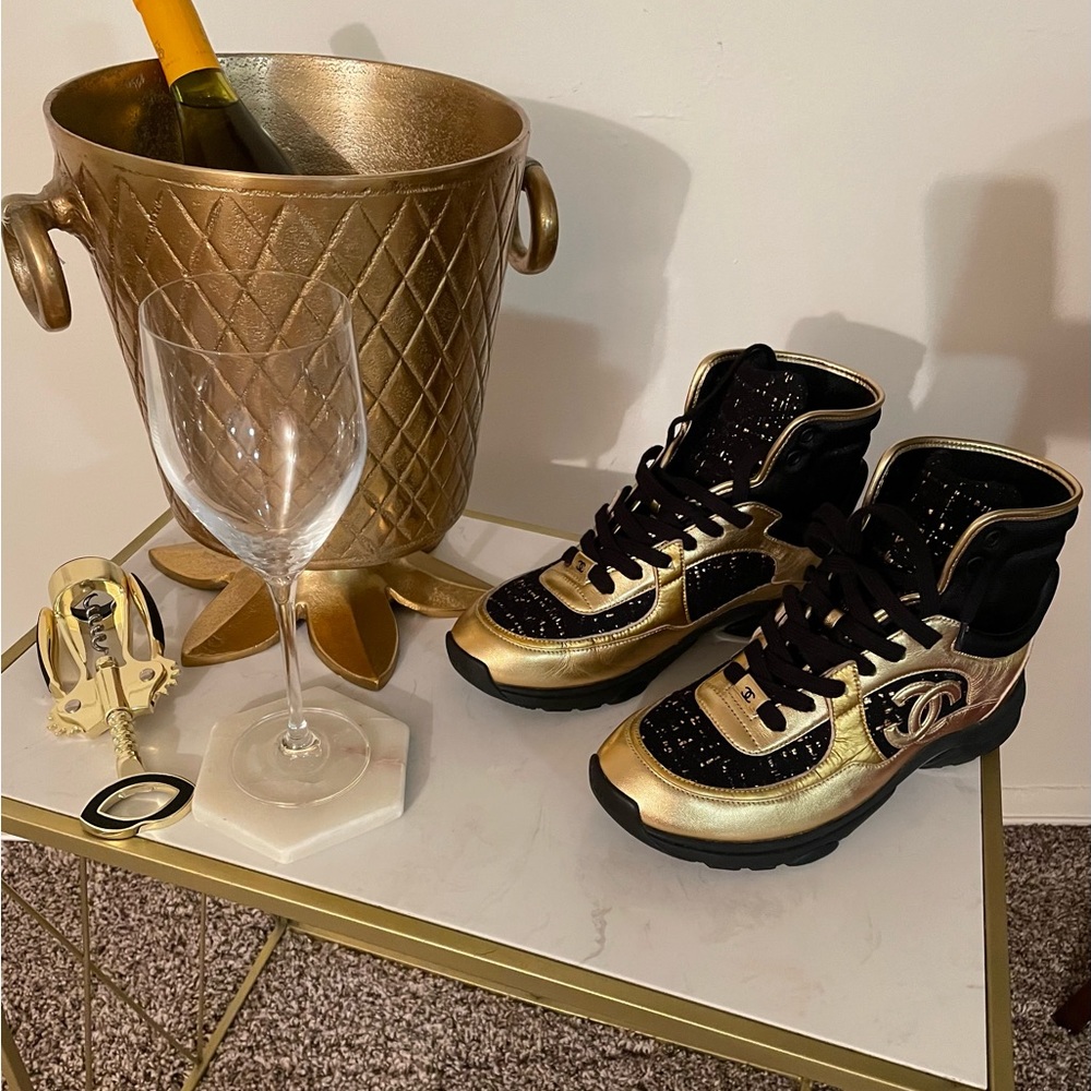 Black and gold leather and tweed hi-top Chanel sneakers in mint condition.